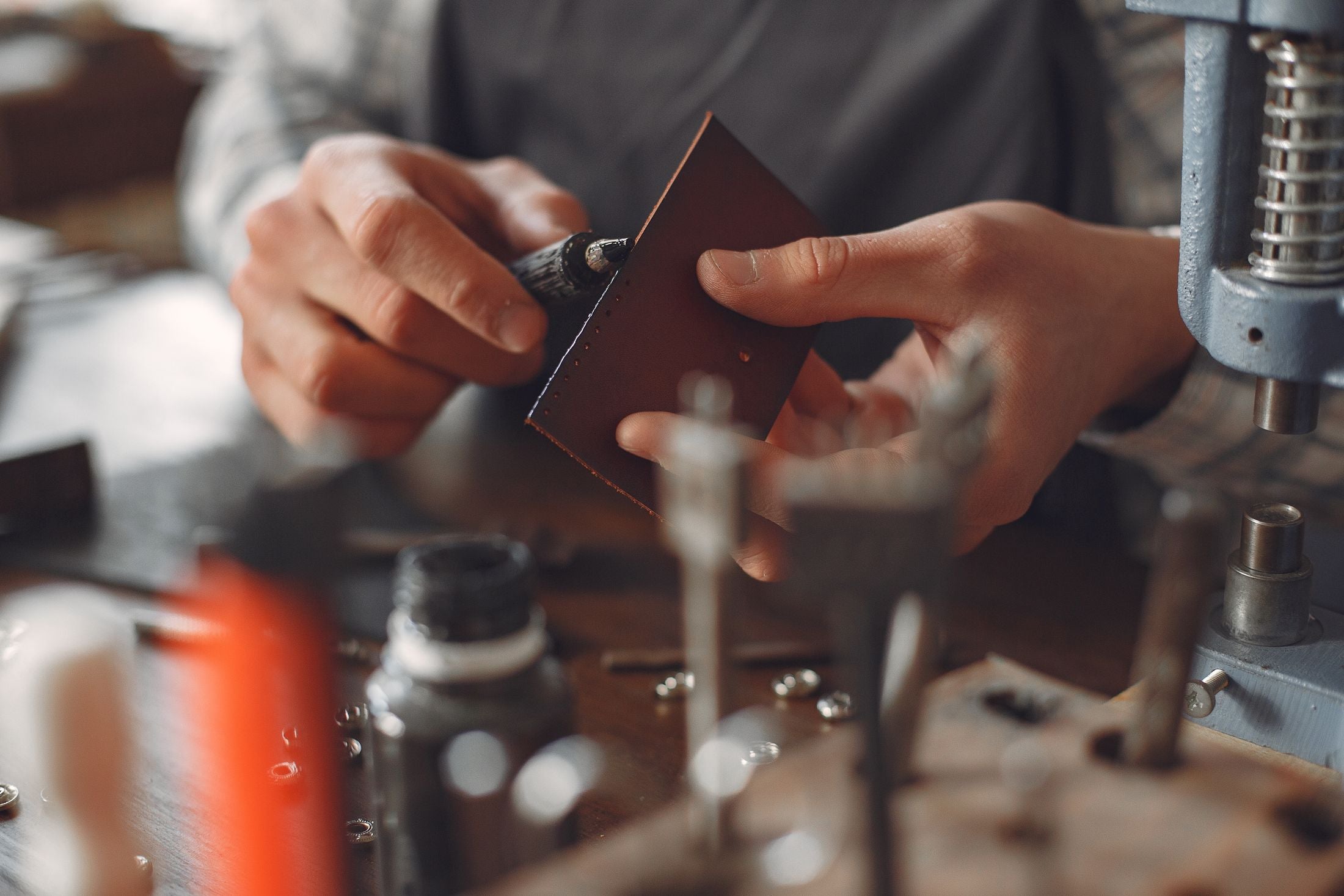 Leather craftsman working by hand